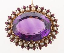 An amethyst, pearl and ruby brooch, claw set to the centre with an oval mixed-cut amethyst,