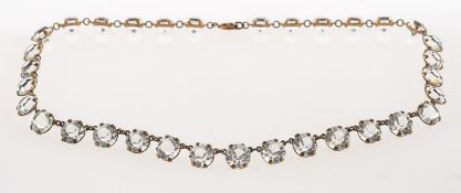 An antique or vintage paste stone rivière necklace,