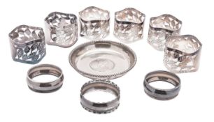 A set of six modern silver napkin rings, with pierced foliate decoration,