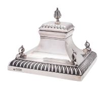A late Victorian silver inkwell, square form with sloping sides,