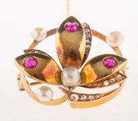 A ruby, pearl and diamond brooch, of circular foliate form, set with three circular-cut rubies,