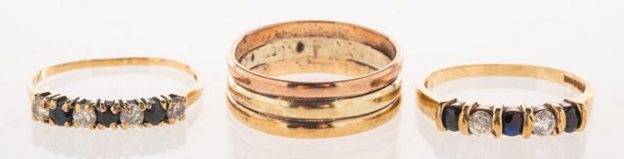 A group of three 9ct gold rings, including a 9ct yellow, white and rose gold wide band ring,