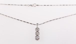 A modern diamond trilogy pendant with chain,