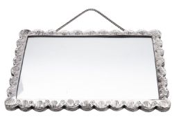 A 20th century Turkish silver mounted mirror, of shaped rectangular outline,