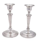 A pair of Elizabeth II silver candlesticks, on circular bases (loaded), with tapering columns,