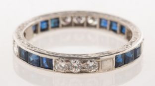 An Art Deco diamond and sapphire full eternity ring,