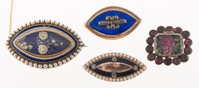 A group of four mourning brooches,