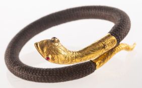 A Victorian hairwork memorial snake bangle, designed as a coiled snake,