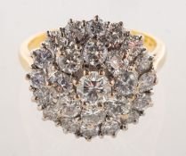 A diamond cluster ring, claw set with twenty-five brilliant-cut diamonds in a tiered design,