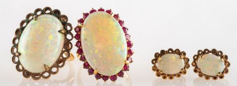 Two opal cocktail rings and a pair of screw back opal earrings,
