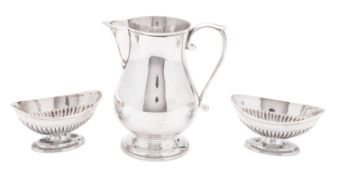 A modern silver milk jug, baluster form, with a sparrow-beak spout,