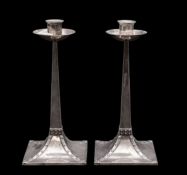 A pair of Edwardian silver candlesticks, on rising square bases, with simulated,