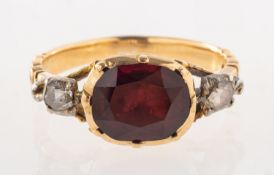 A Georgian garnet and diamond ring, the focus being an oval-cut garnet,