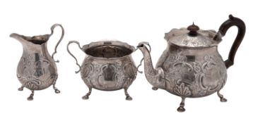 A late Victorian three-piece silver tea set, circular form, with wavy rims, bellied bodies,