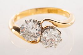 A diamond 'toi et moi' ring, of twist design, claw set with two old European-cut diamonds,