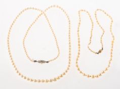 Two cultured pearl necklaces, a long strand of unknotted graduated cultured pearls,