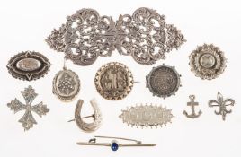 A Victorian silver buckle and a group of various antique brooches,