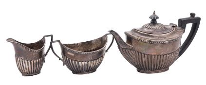 A late Victorian cased three-piece silver tea set, with oval, part-fluted bodies,