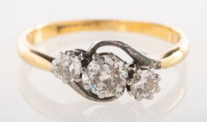 A three stone diamond twist ring, claw set with three old-cut diamonds, diamonds approx. 0.