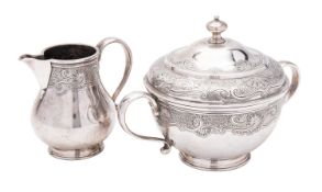 A George V silver sugar bowl & cover and matching milk jug, of circular form, with scroll handles,