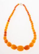 An 'amber type' bead necklace, of graduated oval beads to bolt ring clasp, clasp unmarked,