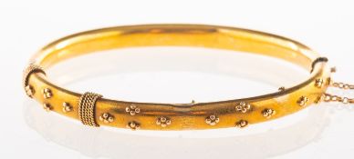 A Victorian hinged bangle, with rope twist and beaded decoration to the front section,