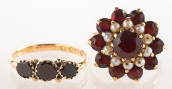 Two garnet set rings,