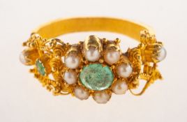 A Victorian emerald and pearl ring, possibly of Indian heritage, and ornate filigree work ring,