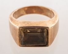 A dress ring, collet set east to west with a rectangular-cut quartz,