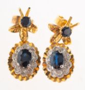 A pair of 18ct gold sapphire and diamond drop earrings, of floral and foliate cluster style,