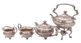 An early 20th century four-piece silver tea set, squat circular form, with husk & scroll borders,