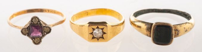 A group of three rings, including a signet style ring,