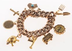 A charm bracelet with charms, a wide hollow link curb chain bracelet, push in clasp,