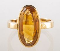 A 9ct gold citrine dress ring, collet set with an elongated oval step-cut citrine, approx. 4.