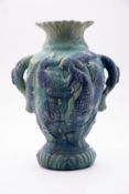 An art pottery vase moulded with fish un