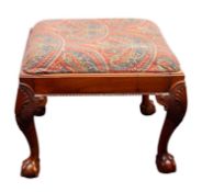A carved walnut stool in the George II s