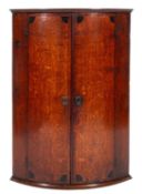 An early 19th Century oak bow fronted ha