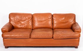 A tan leather upholstered three seat sof