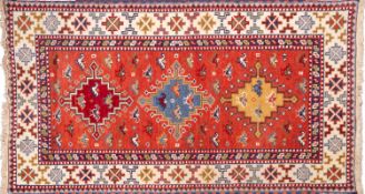 An Afghan Turkoman rug, the red field wi
