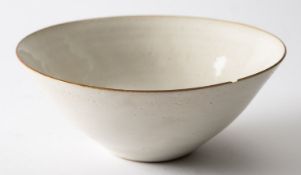 *Dame Lucie Rie DBE [1902-1995] a stoneware bowl with off white glaze and single copper spot,