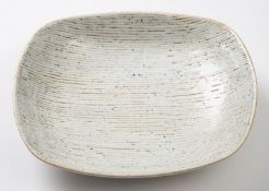 *Dame Lucie Rie DBE [1902-1995] a stoneware dish, of rounded rectangular form the white,