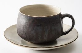 *Dame Lucie Rie DBE [1902-1995] a stone ware cup and saucer the cup with off white interior and