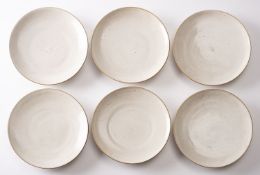*Dame Lucie Rie DBE [1902-1995] six stone ware plates with off white glaze, 18.