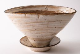 *Dame Lucie Rie DBE [1902-1995] a stoneware planter and stand of squeezed oval form the exterior