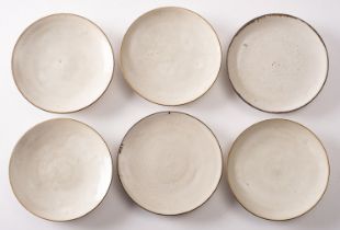 *Dame Lucie Rie DBE [1902-1995] six stone ware saucers with off white glaze and manganese rims,