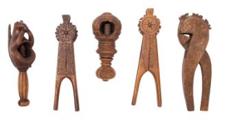 A group of five Scandinavian treen nutcrackers, three of traditional chip carved for,
