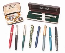 A mixed collection of fountain and ballpoint pens.
