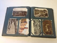An early 20th Century postcard album.