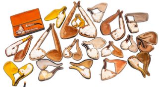 A collection of twenty carved Meerschaum pipes.
