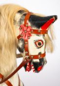 A 20th century painted rocking horse, in black and white with white mane and tail,